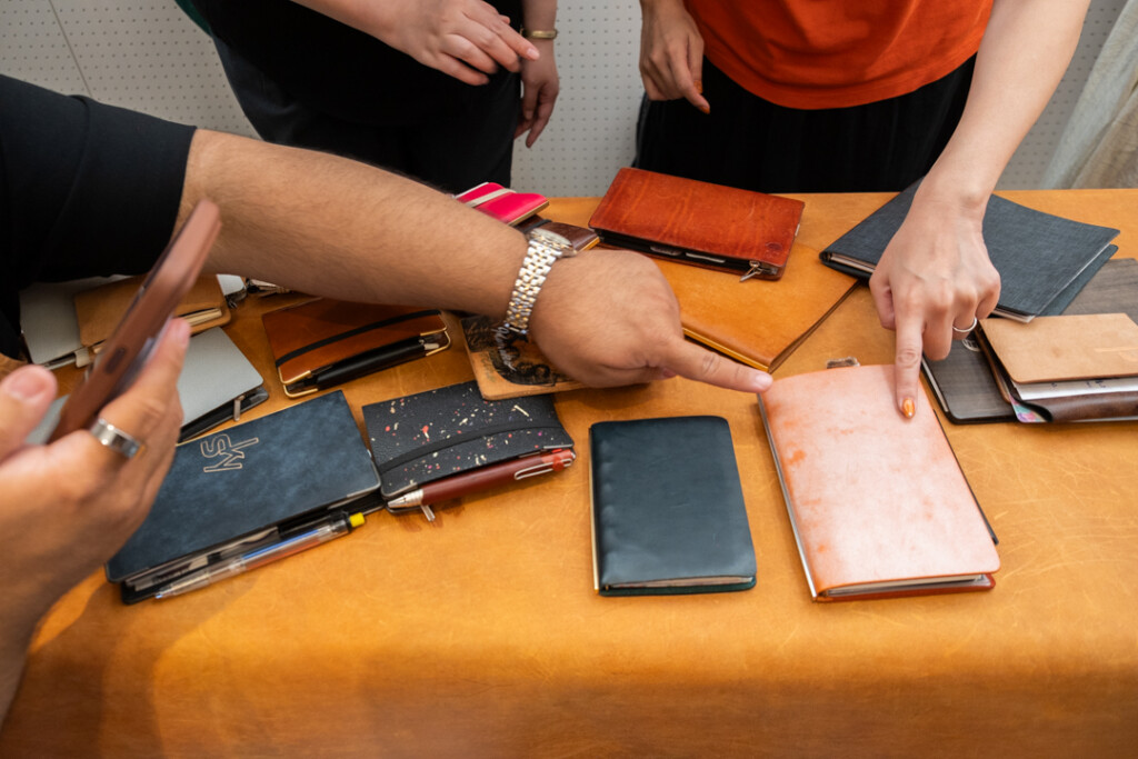 A table filled with PLOTTER Leather Binders at the PLOTTER TOKYO flagship store.