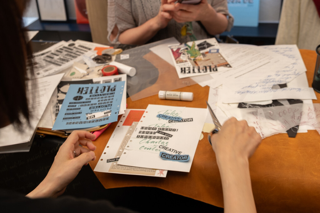 A person collaging during the PLOTTER TOKYO workshop, which takes place on the third floor of PLOTTER TOKYO.