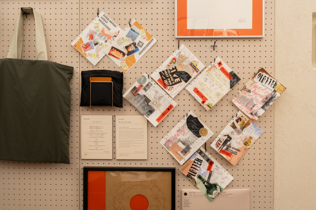 A peg board filled with collages created on PLOTTER Drawing Paper which relate to creativity and use a mixed media approach, which incorporates torn paper, stamps, and calligraphy lettering.