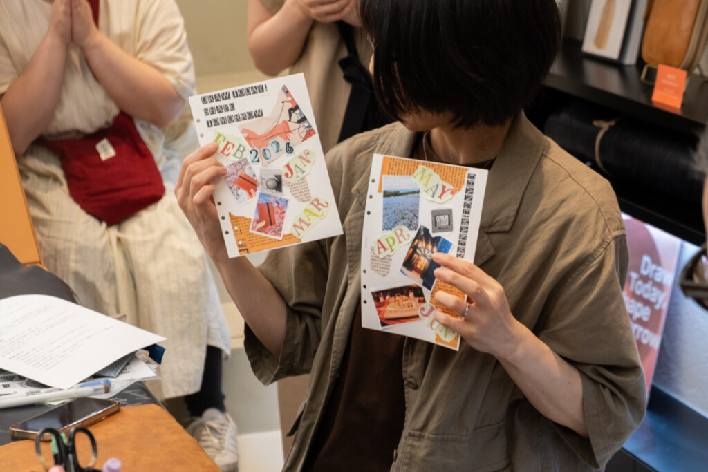 A person showing their completed collages during the PLOTTER TOKYO workshop, which takes place on the third floor of PLOTTER TOKYO.