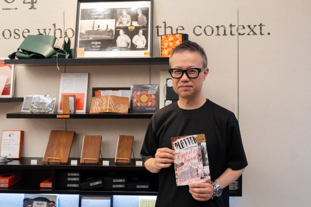 PLOTTER TOKYO workshop with Takayuki Saito, the director of PLOTTER, holding his finished collage.