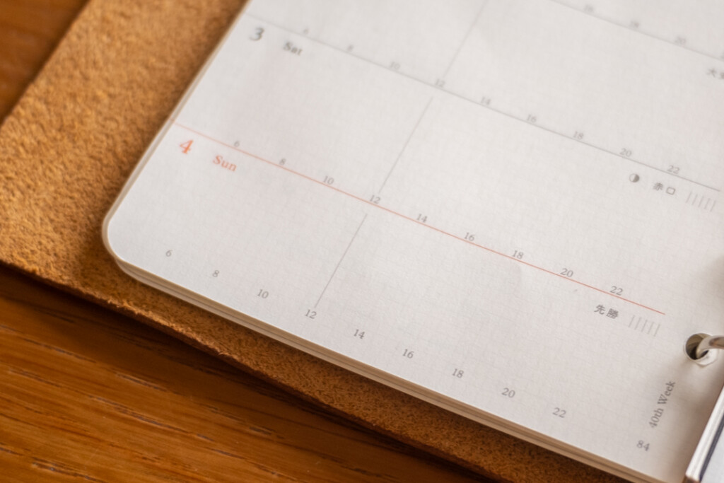 A close up of the daily timeline on the PLOTTER Weekly Schedule Refills in a PLOTTER Leather Binder in Amber.