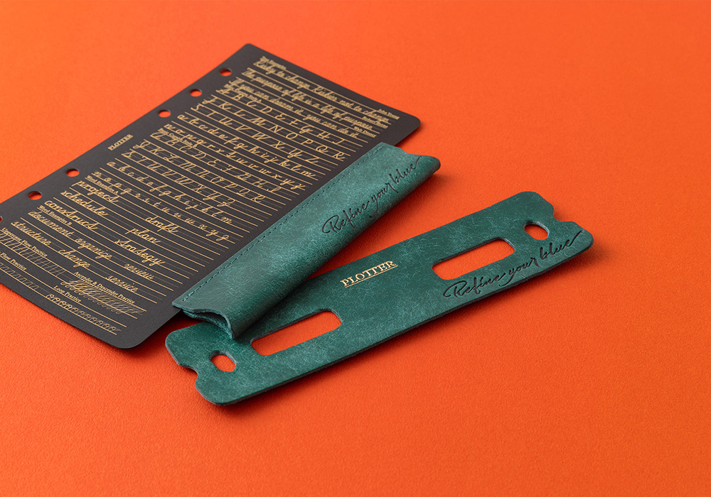 Lifter with Pen Holder and Ring Supporter with matching leather and the phrase "Refine your blue" engraved on it.